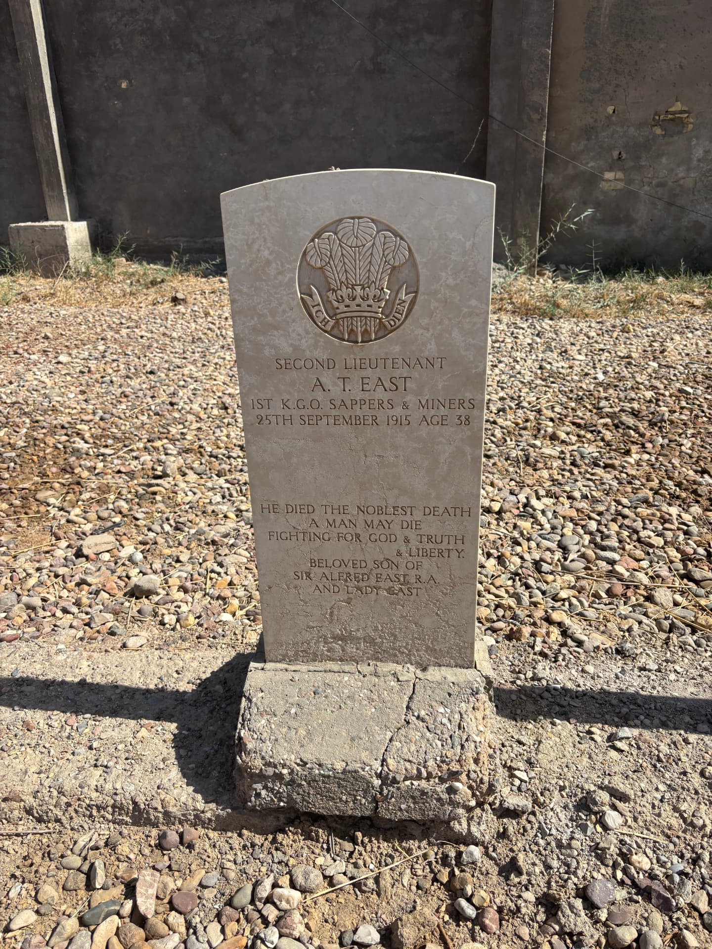 The headstone of Second Lieutenant A. T. East, 1st K.G.O. Sappers and Miners, died 25 September 1915 aged 38, son of the painter Sir Alfred East R.A., with the inscription 'He died the noblest death a man may die, fighting for God and truth and liberty'.