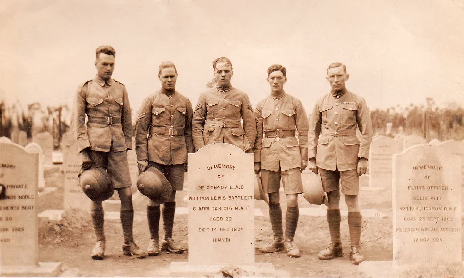 Five airmen at the grave of 326407 Leading Aircraftman William Lewis Bartlett, 6 Armoured Car Company, Royal Air Force, aged 22, died 14 December 1924 at Hinaidi. To the right stands the headstone of Flying Officer Ellis Reid, No. 1 (F) Squadron, RAF, born 23 September 1902, killed in an aeroplane accident 12 November 1924.