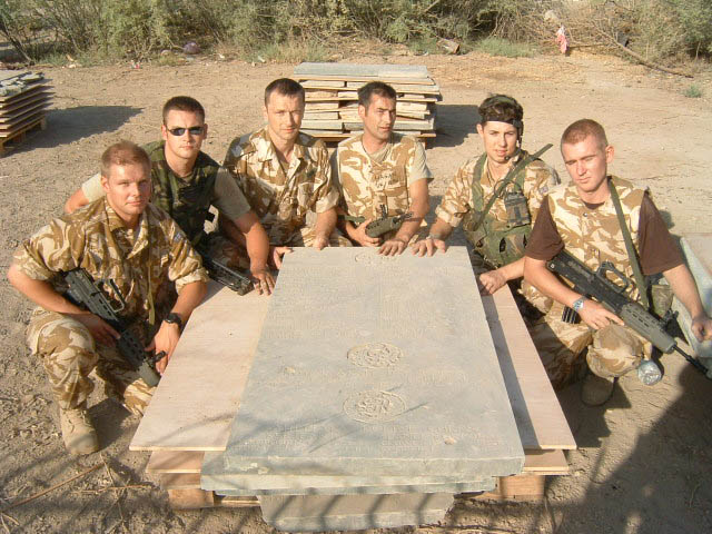 British Army personnel with a memorial panel prepared for removal.