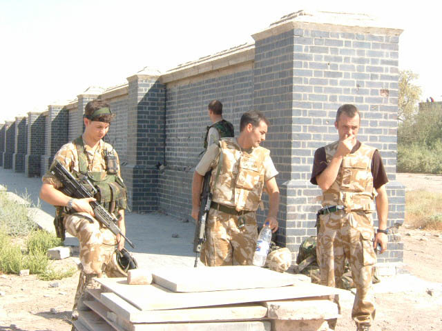 Panels being stacked on pallets for removal with the memorial wall behind.