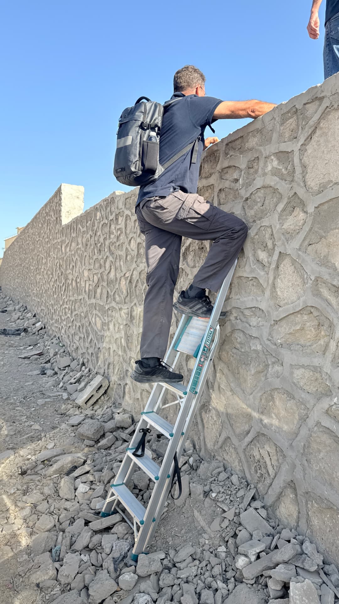 Access to the site required a ladder over the perimeter wall, the new gate being locked, with broken stone and rubble lying along the foot of the wall.
