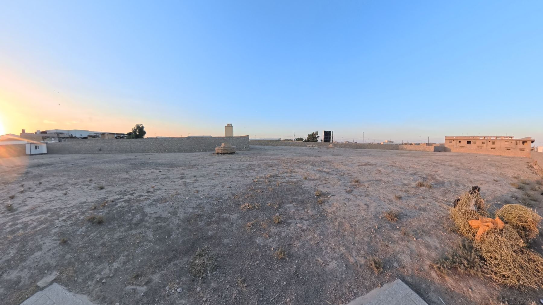 Mosul War Cemetery - Commonwealth War Graves Commission cemetery in Mosul (~350–400 km north of Baghdad), bordered by a major new highway and surrounded by small workshops and truck garages, Iraq