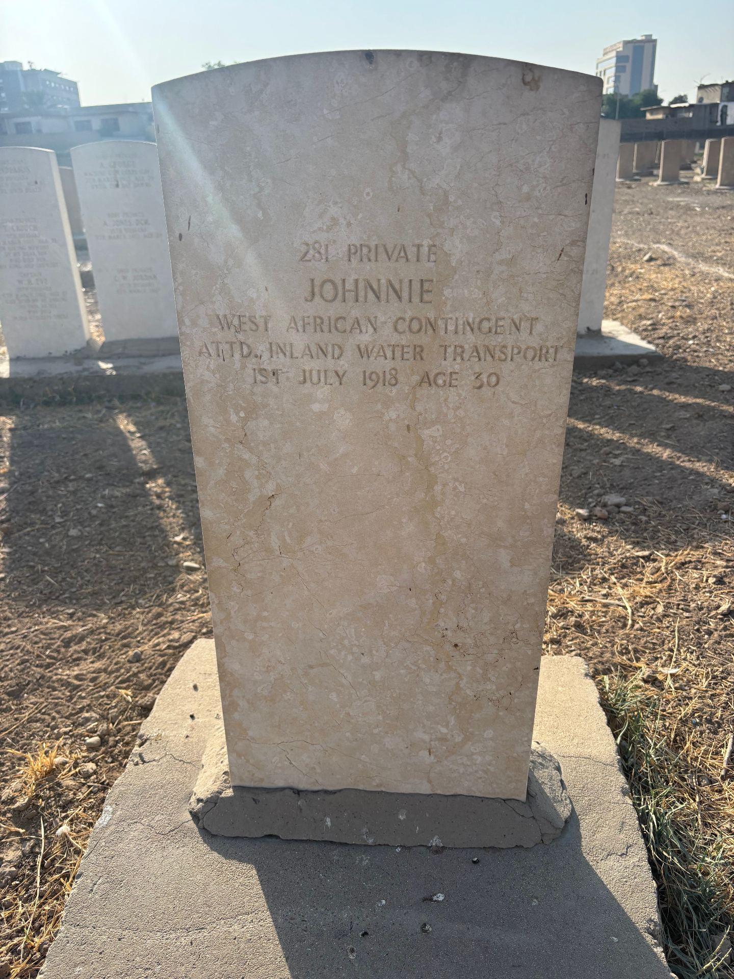 Headstone at Baghdad Northgate to 281 Private Johnnie, West African Contingent attached Inland Water Transport, died 1st July 1918, aged 30.